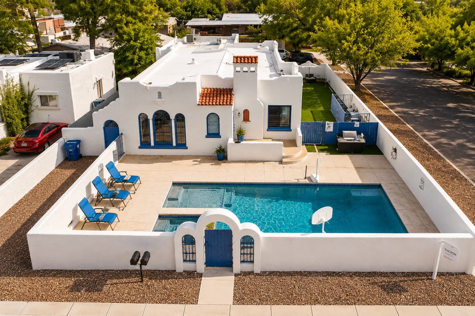 Aerial view of a white Spanish-revival home on Hampton with a walled pool courtyard